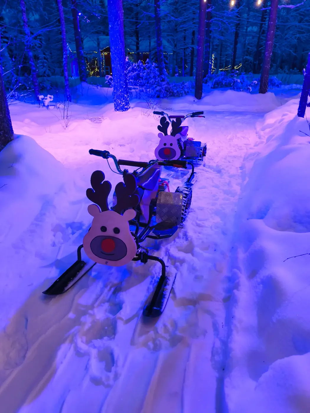 Electric children’s mini snowmobiles with a Rudolf reindeer design at Santa Forest Rovaniemi